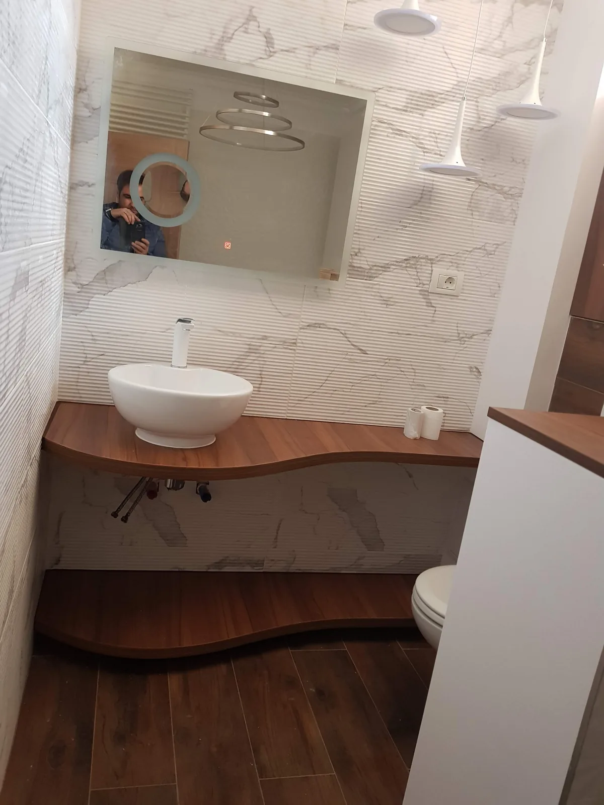 Lavoar pe blat cu mobilier ondulat din lemn, perete marmură — mobilier de baie la comandă Fine Cut Furniture, Timișoara
